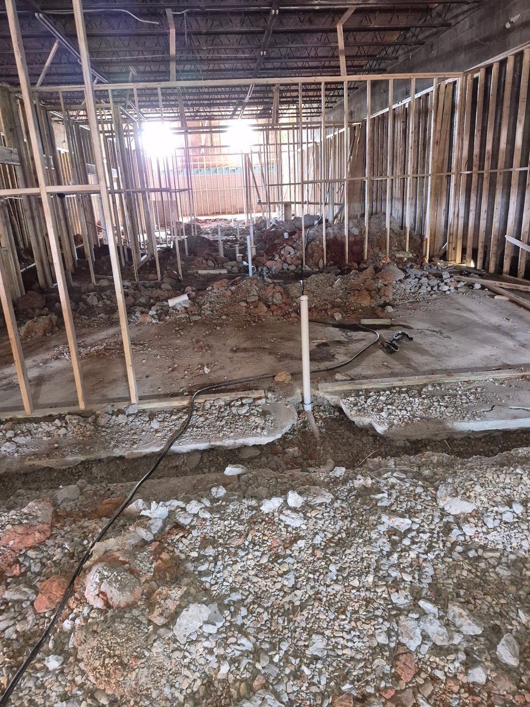 Large commercial building under construction with plumbing